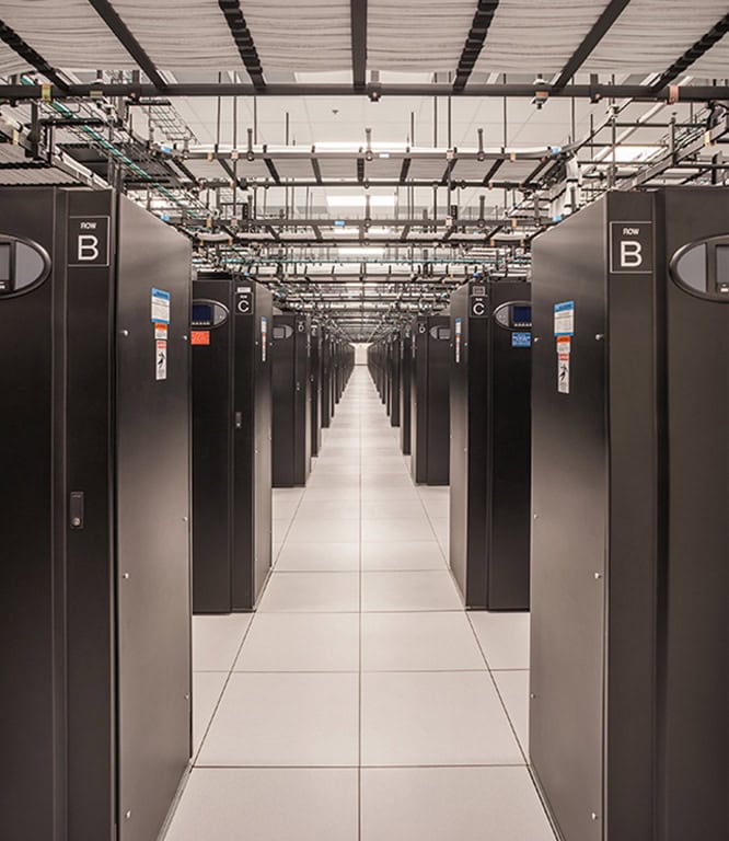 IT Male engineer works on his laptop in data center
